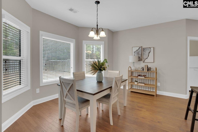 dining room featuring a chandelier and light wood-type flooring