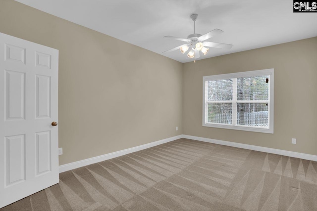 carpeted spare room featuring ceiling fan