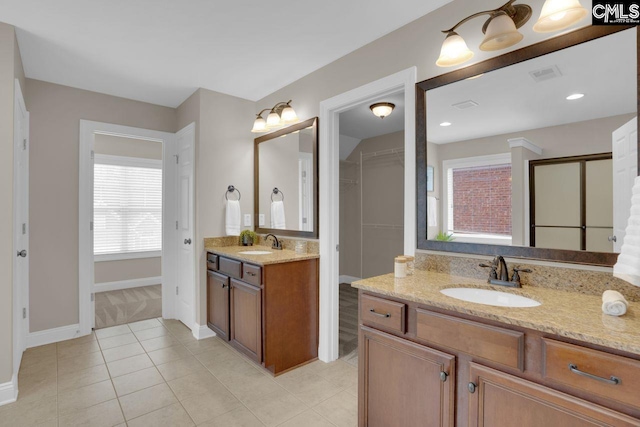 bathroom featuring tile patterned flooring and vanity