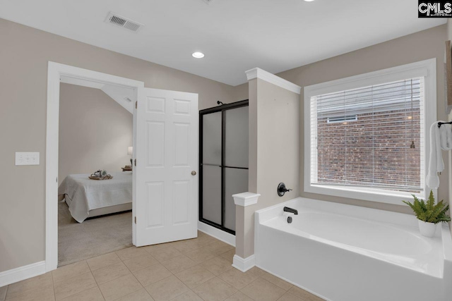 bathroom with tile patterned floors and separate shower and tub