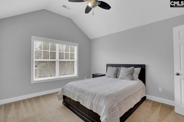 bedroom featuring ceiling fan, light colored carpet, and vaulted ceiling