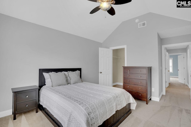 carpeted bedroom with vaulted ceiling and ceiling fan