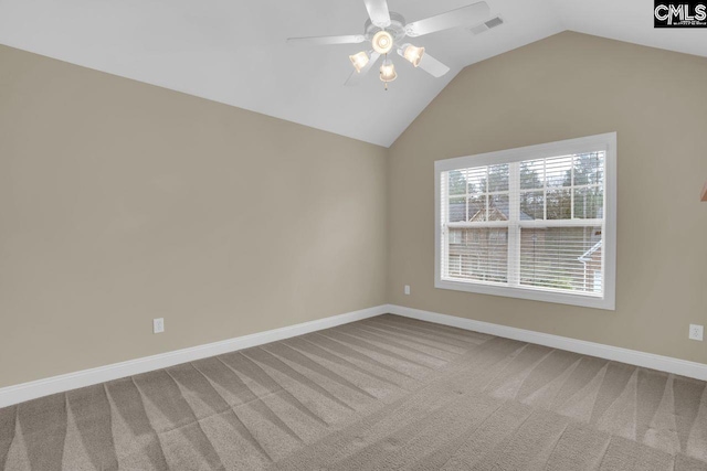 empty room featuring ceiling fan, lofted ceiling, and carpet