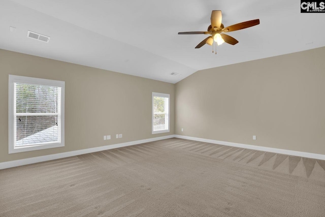 carpeted spare room featuring lofted ceiling and ceiling fan