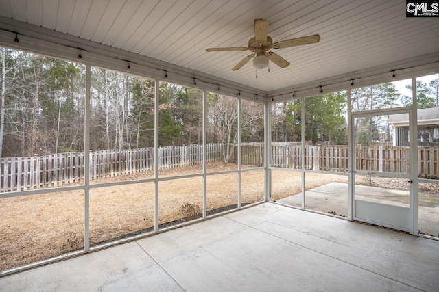 unfurnished sunroom featuring ceiling fan