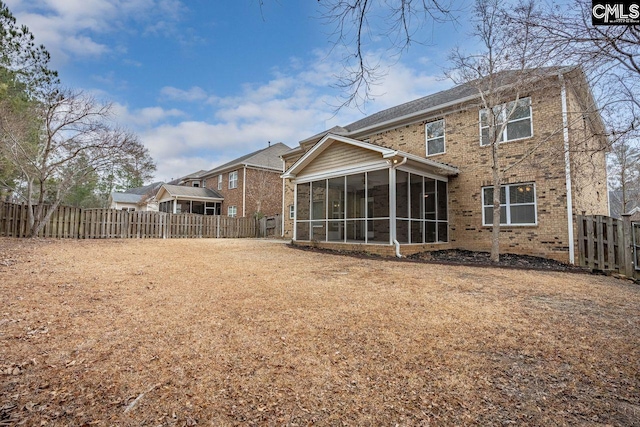 rear view of house with a sunroom