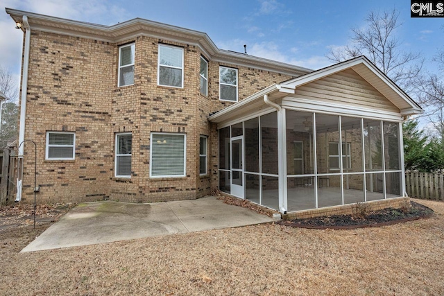 rear view of house with a sunroom and a patio area