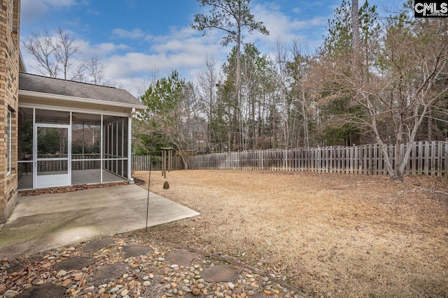 view of yard featuring a sunroom and a patio area