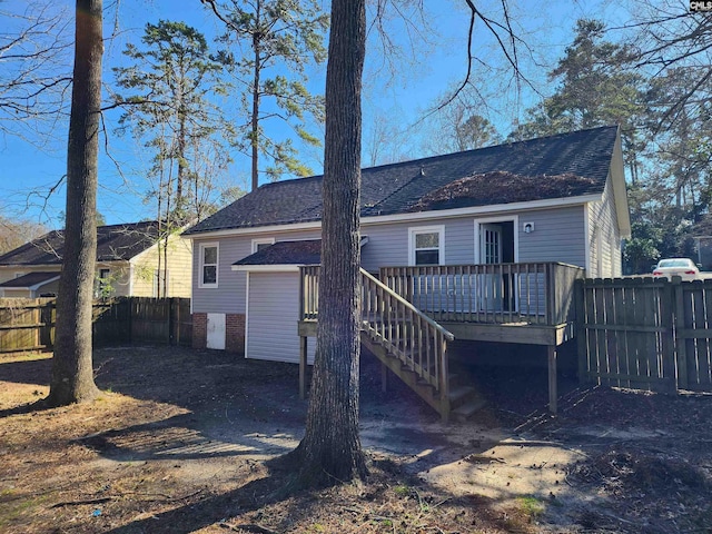 rear view of property featuring a deck