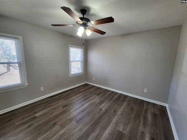 spare room with ceiling fan, dark wood-type flooring, and a textured ceiling