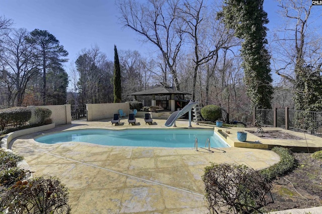 view of pool with a gazebo, a patio area, and a water slide