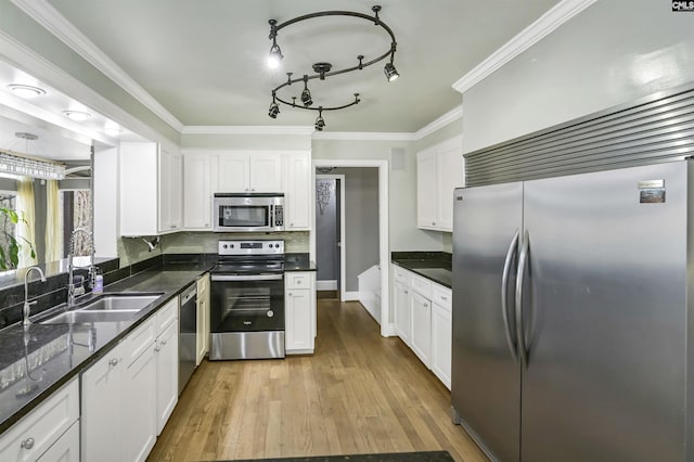 kitchen with white cabinetry, appliances with stainless steel finishes, sink, and light wood-type flooring