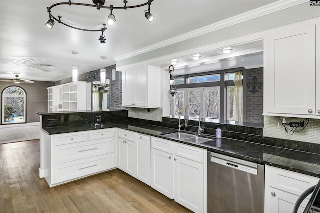 kitchen featuring sink, hanging light fixtures, white cabinets, stainless steel dishwasher, and dark stone counters