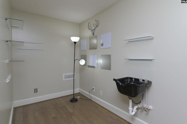 washroom with wood-type flooring