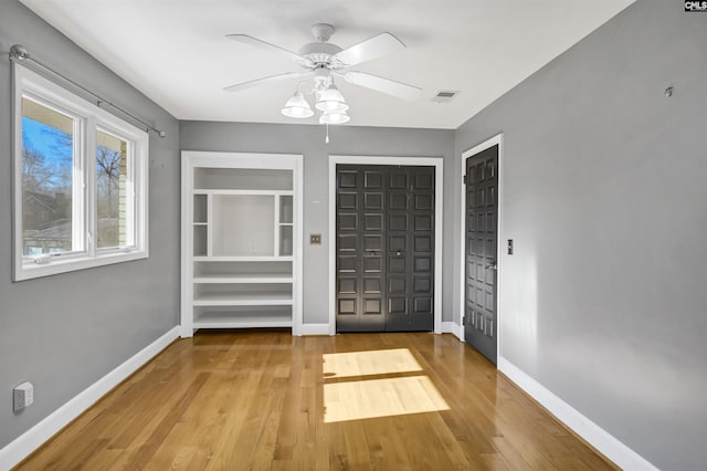 unfurnished bedroom featuring ceiling fan and hardwood / wood-style floors