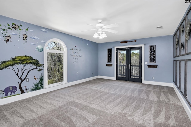 spare room featuring french doors, ceiling fan, and carpet