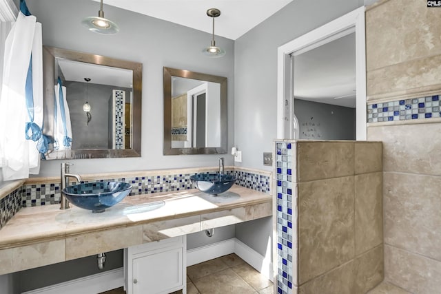 bathroom featuring tile patterned flooring, sink, and decorative backsplash