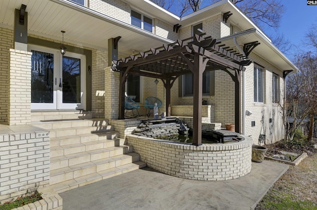 view of patio / terrace with french doors and a pergola