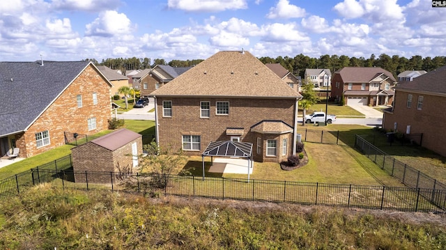 back of property with a gazebo and a lawn