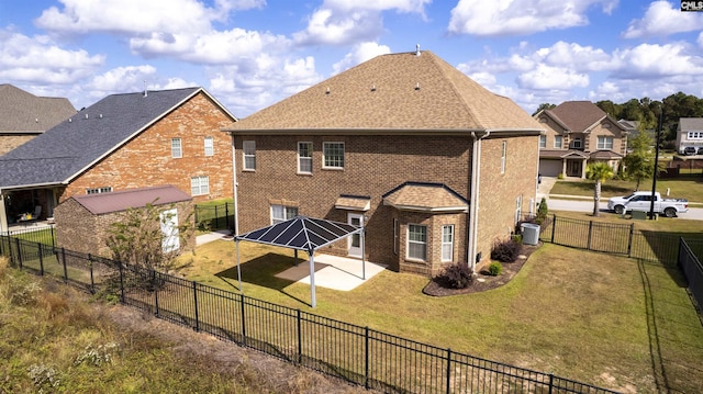 back of house featuring a gazebo, a lawn, a patio, and a storage unit