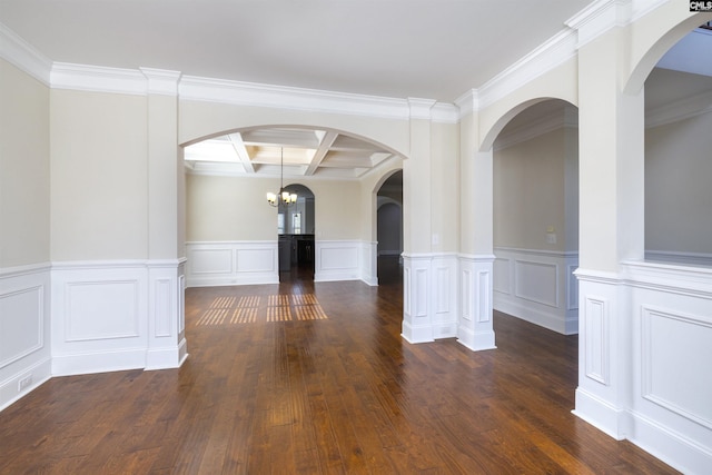 unfurnished room with coffered ceiling, a chandelier, dark hardwood / wood-style floors, and beamed ceiling