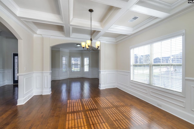 unfurnished dining area with beamed ceiling, dark wood-type flooring, and a wealth of natural light