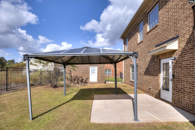 view of car parking with a gazebo and a lawn