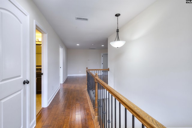 hallway with dark hardwood / wood-style flooring