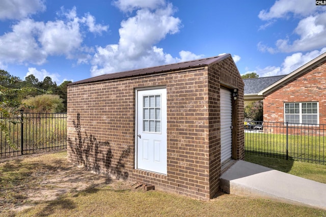 view of outdoor structure featuring a lawn