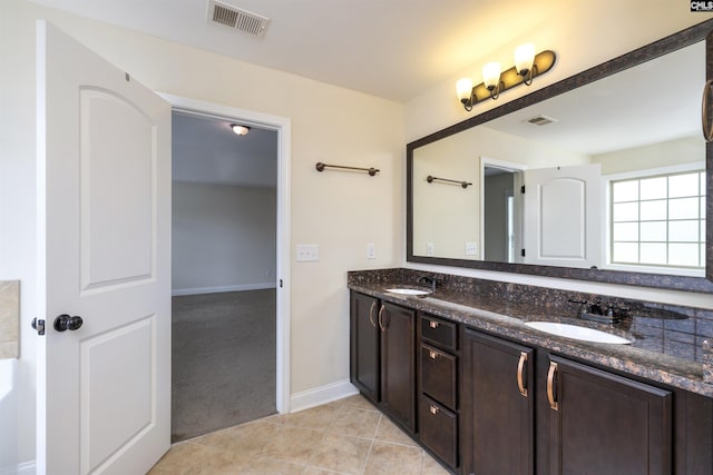 bathroom featuring tile patterned flooring and vanity