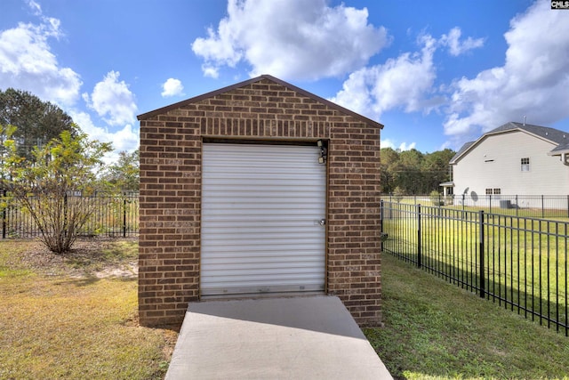 view of outbuilding with a garage and a lawn