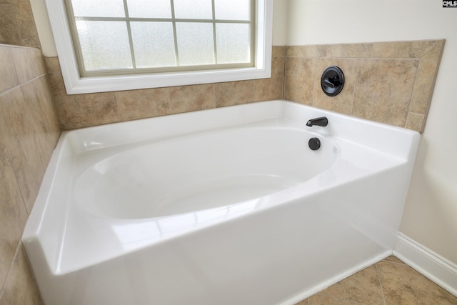 bathroom featuring a washtub and tile patterned floors