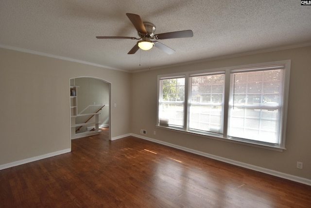 unfurnished room featuring crown molding, ceiling fan, dark hardwood / wood-style floors, and a textured ceiling