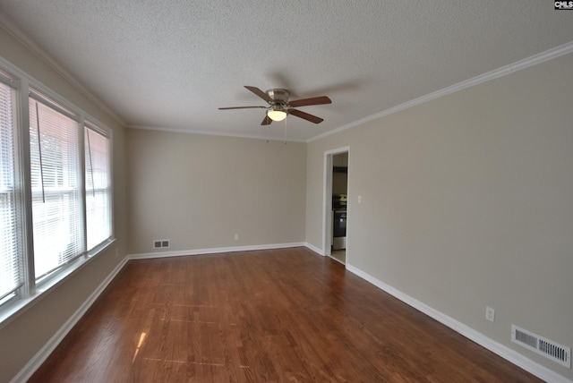 empty room with crown molding, dark wood-type flooring, and a textured ceiling