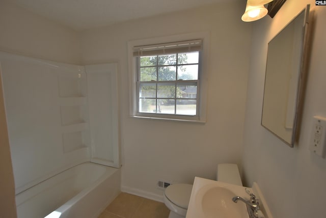 full bathroom with tile patterned flooring, sink, washtub / shower combination, and toilet