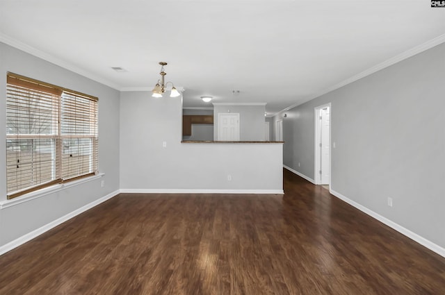 unfurnished living room featuring ornamental molding, dark hardwood / wood-style floors, and a notable chandelier