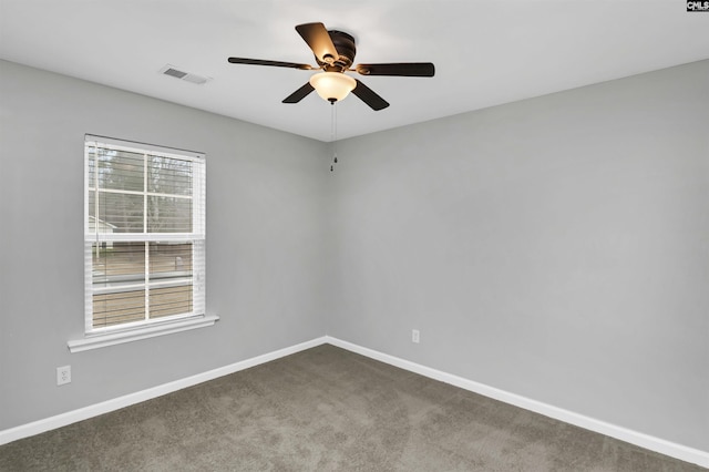 carpeted spare room featuring ceiling fan