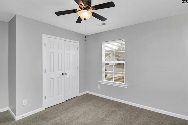 unfurnished bedroom with carpet floors, a closet, and ceiling fan