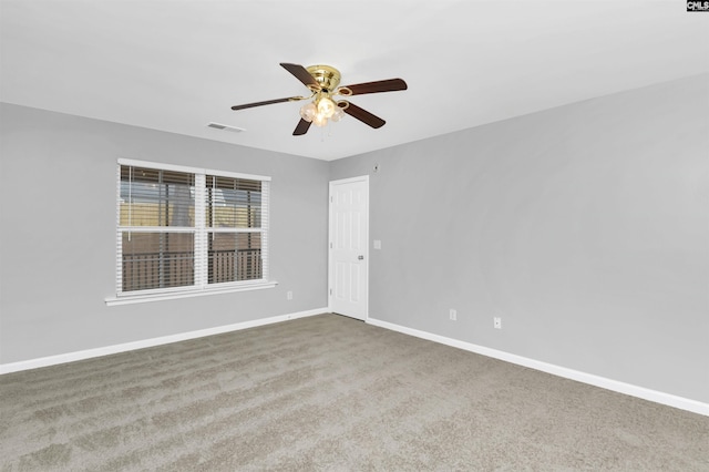 empty room with ceiling fan and carpet flooring