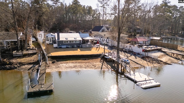 dock area with a patio and a water view