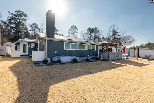 back of property with a gazebo