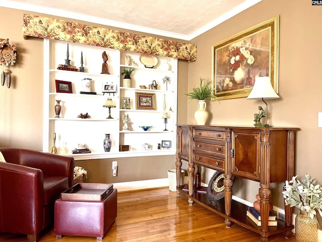 sitting room featuring ornamental molding and hardwood / wood-style floors