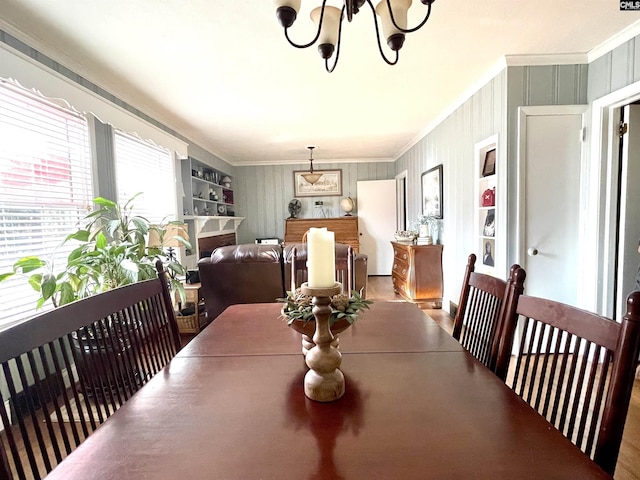 dining area featuring an inviting chandelier and crown molding