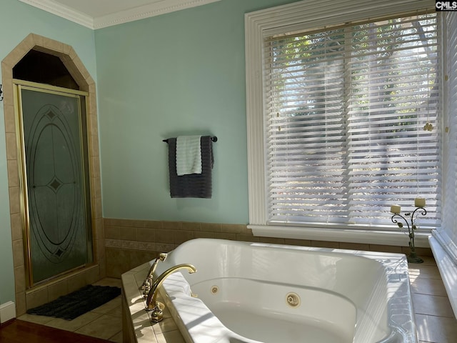 bathroom featuring a relaxing tiled tub, tile patterned floors, and ornamental molding