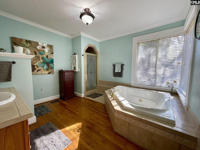 bathroom with vanity, separate shower and tub, wood-type flooring, and ornamental molding