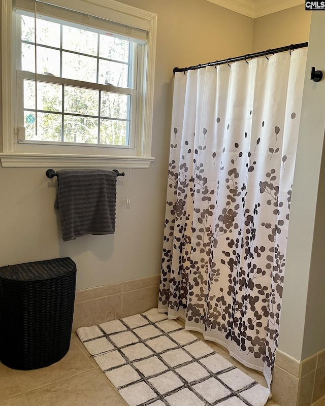 bathroom with a shower with shower curtain and tile patterned flooring