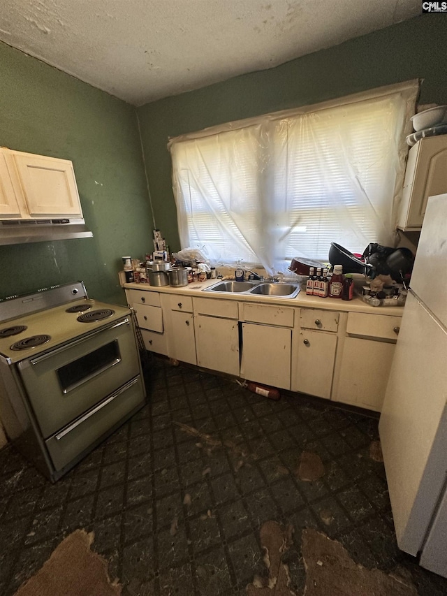 kitchen with range with electric cooktop, light countertops, a sink, and dark floors