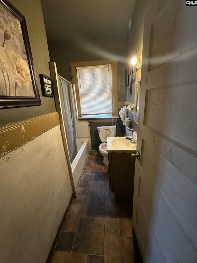 bathroom with toilet, shower / tub combo, and vanity