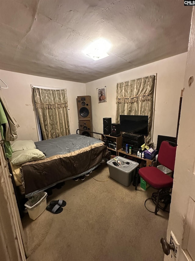 bedroom featuring concrete flooring