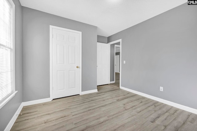 unfurnished bedroom featuring light wood-type flooring